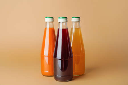 Bottles of juices on color background