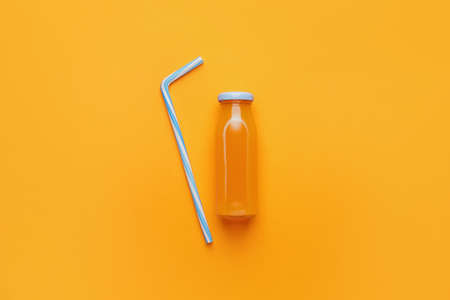 Bottle of juice on color backgroundの写真素材