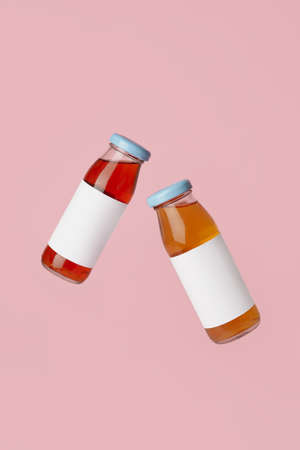 Bottles of juices on color backgroundの写真素材