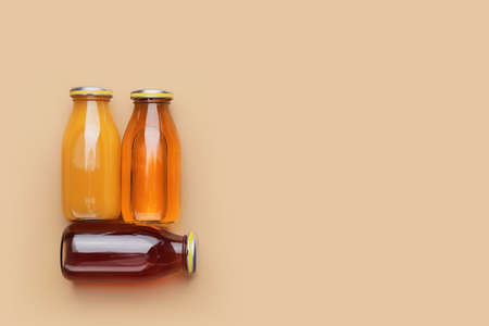 Bottles of juices on color backgroundの写真素材