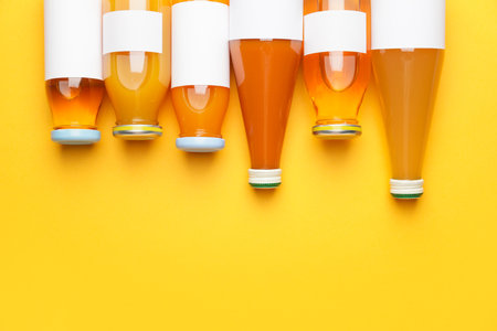 Bottles of juices on color backgroundの写真素材