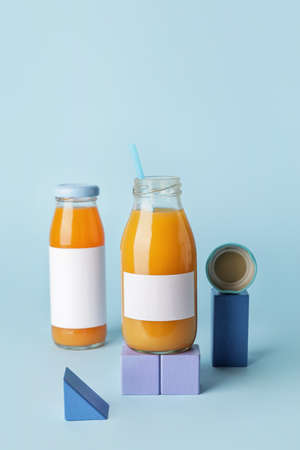 Bottles of juices on color background
