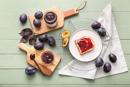 Composition with delicious homemade plum jam on wooden backgroundの写真素材