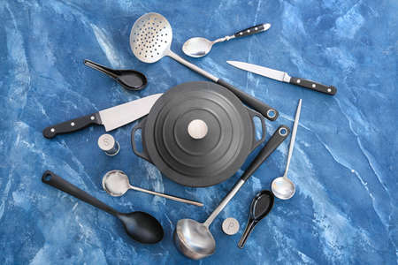 Composition with cooking pot and kitchenware on color backgroundの写真素材