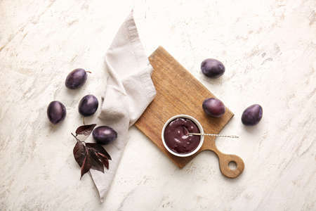 Bowl with delicious homemade plum jam on tableの写真素材