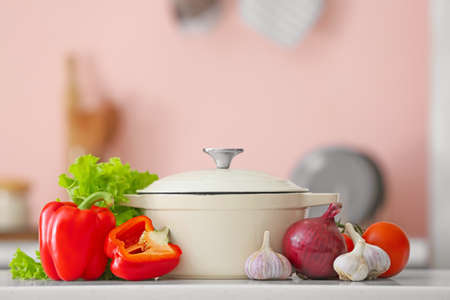 Cooking pot with vegetables on blurred backgroundの写真素材
