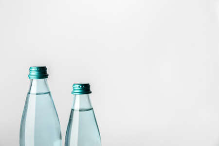 Bottles of clean water on light backgroundの写真素材