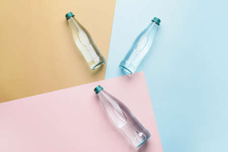 Bottles of clean water on color backgroundの写真素材