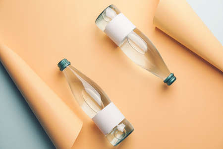 Bottles of clean water on color background
