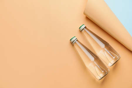 Bottles of clean water on color backgroundの写真素材