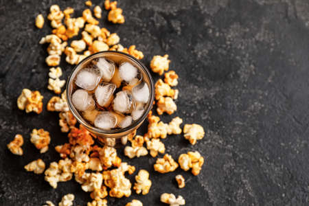 Tasty popcorn and cola on grunge backgroundの写真素材