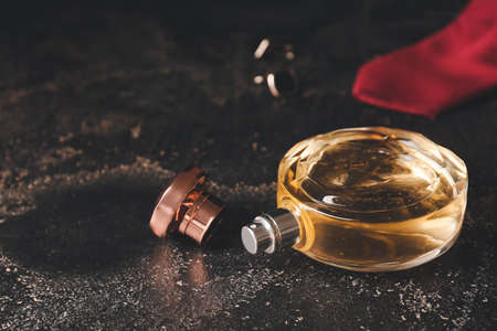 Bottle of perfume on dark table