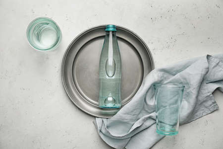 Bottle of clean water and glasses on light backgroundの写真素材