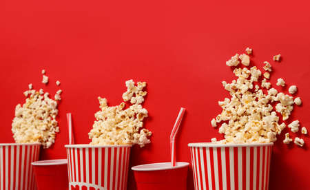 Tasty popcorn and cola on color backgroundの写真素材