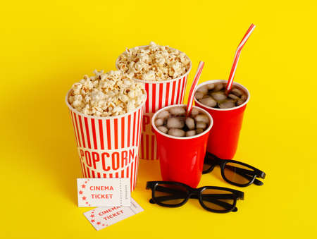 Composition with popcorn, cola, cinema tickets and 3D glasses on color backgroundの写真素材