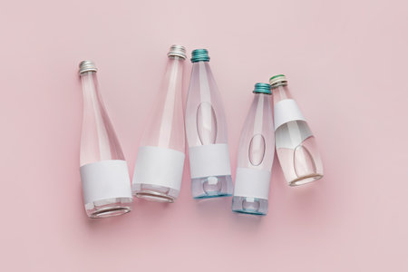 Bottles of clean water on color backgroundの写真素材