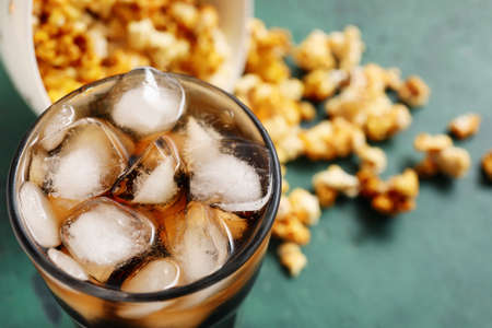 Tasty popcorn and cola on color background, closeupの写真素材