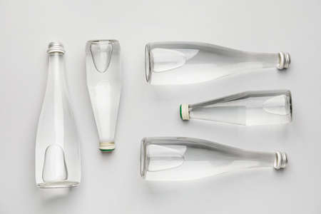 Bottles of clean water on light background