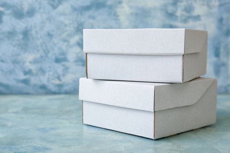 Blank cardboard boxes on color backgroundの写真素材