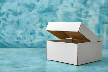 Blank cardboard box on color backgroundの写真素材