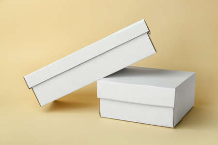 Blank cardboard boxes on color background