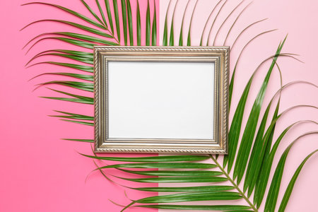 Blank paper sheet with frame and green leaf on color backgroundの写真素材