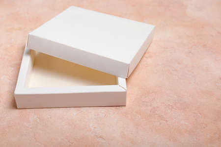 Blank cardboard boxes on color background