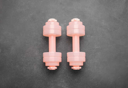 Stylish dumbbells on dark background