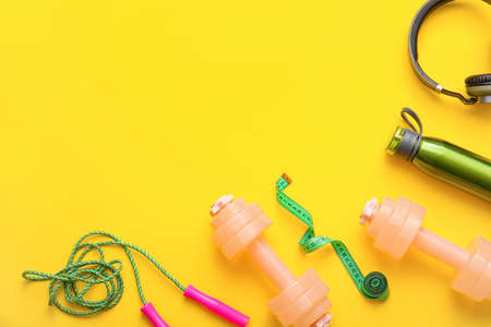 Stylish dumbbells on color backgroundの写真素材