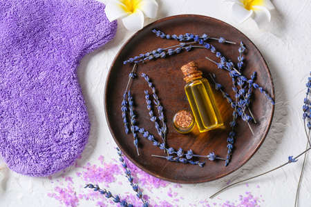 Tray with bottles of lavender essential oil on tableの写真素材