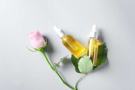 Bottles with floral essential oil on light backgroundの写真素材