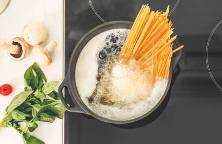 Pasta boiling in cooking pot on electric stove