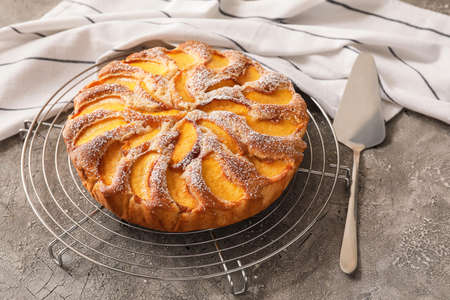 Tray with tasty peach pie on grunge backgroundの写真素材