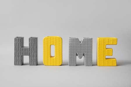 Decor in shape of word HOME on gray backgroundの写真素材