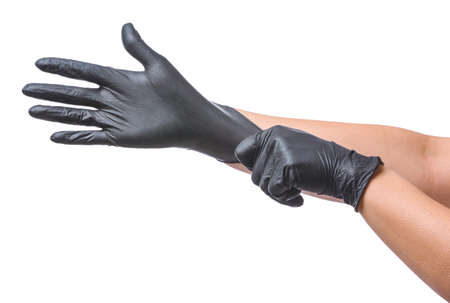 Woman putting on protective gloves on white background