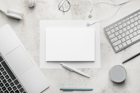 Composition with blank card, computers and stationery on light backgroundの写真素材