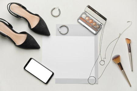 Composition with blank card, female accessories and mobile phone on white backgroundの写真素材