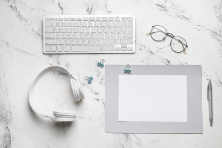 Composition with blank card, computer keyboard and headphones on white backgroundの写真素材