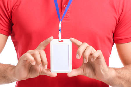 Young man with blank badge in uniform on white background, closeupの写真素材