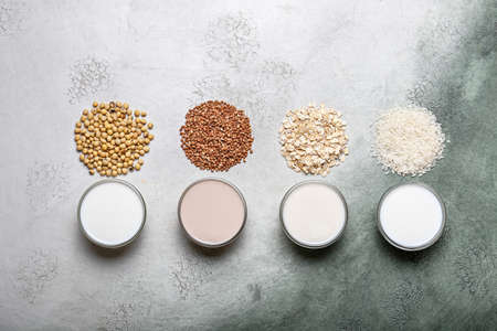 Glasses of different milk on color backgroundの写真素材