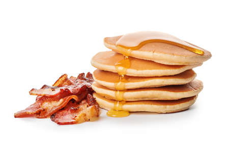 Tasty pancakes with fried bacon on white backgroundの写真素材