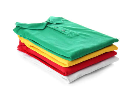 Stack of folded polo shirts on white backgroundの写真素材