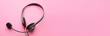 Headphones with microphone on color background with space for textの写真素材