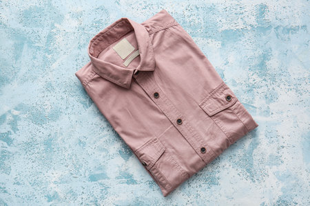 Folded male shirt on light backgroundの写真素材