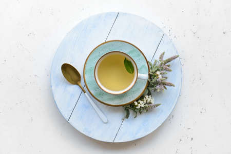 Cup with herbal tea on light backgroundの写真素材