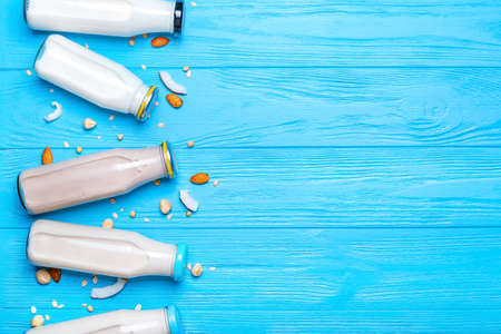 Bottles of different milk on wooden backgroundの写真素材