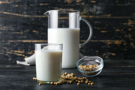 Jug and glass of soy milk on tableの写真素材