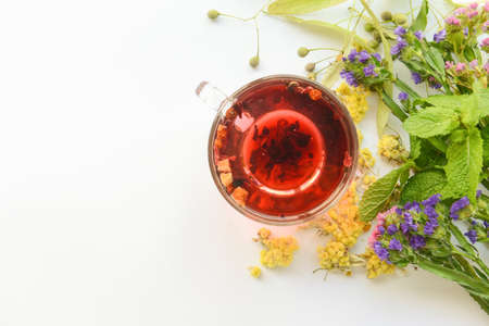 Dry flowers, herbs and cup of floral tea on white backgroundの写真素材