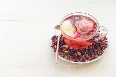 Cup with floral tea on light backgroundの写真素材