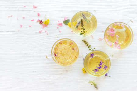Cups with floral tea on light backgroundの写真素材